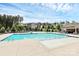 Community pool featuring ample seating, clear blue water, and a cabana for shade at 16019 Kelby Cv, Charlotte, NC 28278