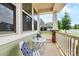 Inviting covered porch with white furniture, providing a cozy outdoor seating area at 16019 Kelby Cv, Charlotte, NC 28278