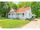 A charming home boasts a spacious yard, complemented by mature trees offering both shade and scenic beauty at 1712 S Main St, Salisbury, NC 28144