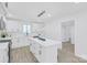 Bright, open kitchen with an island, modern light fixtures and new white cabinetry at 1712 S Main St, Salisbury, NC 28144