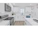 Well-lit kitchen with white countertops and cabinets, stainless steel appliances, and an efficient layout at 1712 S Main St, Salisbury, NC 28144