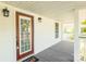 Charming covered front porch with a wood front door and new outdoor lighting at 1712 S Main St, Salisbury, NC 28144