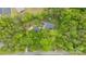 Aerial view of the home surrounded by trees, complemented by its back deck and other outbuildings on the property at 17403 Green Hill Rd, Charlotte, NC 28278