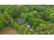 Aerial shot of the property showcasing the home and a detached garage settled among mature trees, offering privacy and seclusion at 17403 Green Hill Rd, Charlotte, NC 28278