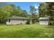 Expansive backyard featuring lush greenery and a detached shed at 17403 Green Hill Rd, Charlotte, NC 28278