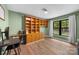 Bedroom featuring hardwood floors, a large window, and built-in cabinets at 17403 Green Hill Rd, Charlotte, NC 28278