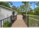 View of deck with black metal railings and access to backyard and firepit at 17403 Green Hill Rd, Charlotte, NC 28278