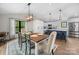 Dining area with a wooden table, elegant chairs, and modern lighting adjacent to the kitchen at 17403 Green Hill Rd, Charlotte, NC 28278
