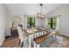 Dining room with a wooden table, seating for six, and a view of the outdoors through black-framed windows at 17403 Green Hill Rd, Charlotte, NC 28278