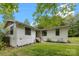 Charming single-story home with white siding, black-framed windows, and a well-maintained lawn at 17403 Green Hill Rd, Charlotte, NC 28278