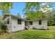 Exterior shot of a charming home featuring light-colored siding and a well-manicured front yard with mature trees at 17403 Green Hill Rd, Charlotte, NC 28278