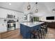 Well-equipped kitchen with stainless steel appliances, white cabinets, and a center island with seating at 17403 Green Hill Rd, Charlotte, NC 28278