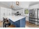 Stylish kitchen with white cabinetry, a blue island with a white countertop, and modern stainless steel appliances at 17403 Green Hill Rd, Charlotte, NC 28278