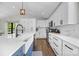Bright kitchen featuring white cabinets, subway tile backsplash, stainless appliances, and hardwood floors at 17403 Green Hill Rd, Charlotte, NC 28278