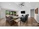 Bright living room with vaulted ceilings, hardwood floors, and sliding glass doors to a screened porch at 17403 Green Hill Rd, Charlotte, NC 28278