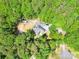 Aerial view of home nestled amongst lush greenery, showcasing privacy and serene setting at 1800 Oriole Ct, Monroe, NC 28112