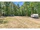 A grass backyard with plenty of parking, trucks, and an RV ready to go at 1800 Oriole Ct, Monroe, NC 28112