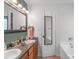 Bright bathroom features a double vanity with granite countertop and neutral color palette at 1800 Oriole Ct, Monroe, NC 28112