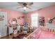Charming bedroom with hardwood floors, a ceiling fan, and lovely decor at 1800 Oriole Ct, Monroe, NC 28112