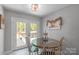 Cozy breakfast nook with access to the deck provides an inviting space for casual dining at 1800 Oriole Ct, Monroe, NC 28112
