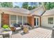 A backyard deck with a brick fireplace and outdoor seating, with French doors leading inside at 1800 Oriole Ct, Monroe, NC 28112