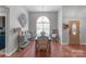 Bright dining room features a wooden table, cherry hardwood floors, and ample natural light from a large arched window at 1800 Oriole Ct, Monroe, NC 28112