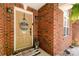 Charming home entrance with brick facade, decorative door, welcome mat, and sunflower accents at 1800 Oriole Ct, Monroe, NC 28112