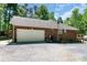 A large brick two story home with gravel parking and a back deck area at 1800 Oriole Ct, Monroe, NC 28112