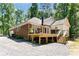 Two story home with a back deck, surrounded by woods and gravel parking at 1800 Oriole Ct, Monroe, NC 28112
