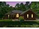Charming brick home with manicured lawn and inviting entrance, nestled among mature trees at 1800 Oriole Ct, Monroe, NC 28112