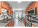 Spacious kitchen featuring wood cabinets, stainless steel appliances, and a breakfast nook with access to the deck at 1800 Oriole Ct, Monroe, NC 28112