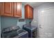 Functional laundry room with front-loading washer/dryer and above cabinets at 1800 Oriole Ct, Monroe, NC 28112
