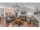 Inviting living room with vaulted ceiling, fan, hardwood floors, and comfortable leather sofas at 1800 Oriole Ct, Monroe, NC 28112