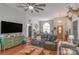 Open-concept living room featuring a ceiling fan, hardwood floors, and comfortable seating arrangements at 1800 Oriole Ct, Monroe, NC 28112