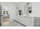 Bathroom featuring double vanity with white cabinets and ensuite bedroom access at 1829 Union St, Charlotte, NC 28205