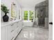 Bright bathroom featuring a double vanity, soaking tub, and glass-enclosed shower at 1829 Union St, Charlotte, NC 28205
