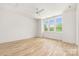 Well-lit bedroom featuring hardwood floors, a ceiling fan, and a large window at 1829 Union St, Charlotte, NC 28205