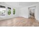 Bright bedroom boasts hardwood floors, a ceiling fan, and a door to the main staircase at 1829 Union St, Charlotte, NC 28205