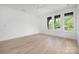 Bright bedroom features hardwood floors, a ceiling fan, and sun-filled windows with natural views at 1829 Union St, Charlotte, NC 28205