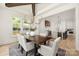 Bright dining room with modern chandelier, wood table, seating for six and view into kitchen with island at 1829 Union St, Charlotte, NC 28205