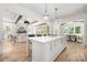 Open-concept living area and kitchen with large island, white cabinets, and stainless steel appliances at 1829 Union St, Charlotte, NC 28205