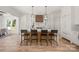 A bright and airy kitchen island featuring four bar stools, white countertops, and wooden base and cabinets at 1829 Union St, Charlotte, NC 28205