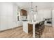 A bright and airy kitchen island featuring black bar stools, white countertops, and wooden base and cabinets at 1829 Union St, Charlotte, NC 28205