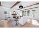 Bright, expansive living room with wood floors, beamed ceilings, and a cozy fireplace at 1829 Union St, Charlotte, NC 28205