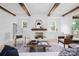 Cozy living room with exposed ceiling beams, a decorative fireplace, and stylish furnishings at 1829 Union St, Charlotte, NC 28205