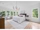 Bright, spacious main bedroom featuring lots of windows, an area rug, and modern chandelier at 1829 Union St, Charlotte, NC 28205