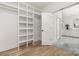Bright walk-in closet with custom shelving and access to the Primary bath at 1829 Union St, Charlotte, NC 28205