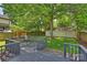 Outdoor space featuring a deck, mature trees, landscaped yard, and a detached garage at 2015 Club Rd, Charlotte, NC 28205