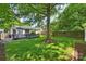 Spacious backyard featuring a large tree, a well-maintained lawn, and a wooden deck, perfect for outdoor entertaining at 2015 Club Rd, Charlotte, NC 28205