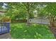 Great backyard featuring a lush lawn, mature tree, and detached garage with a deck at 2015 Club Rd, Charlotte, NC 28205